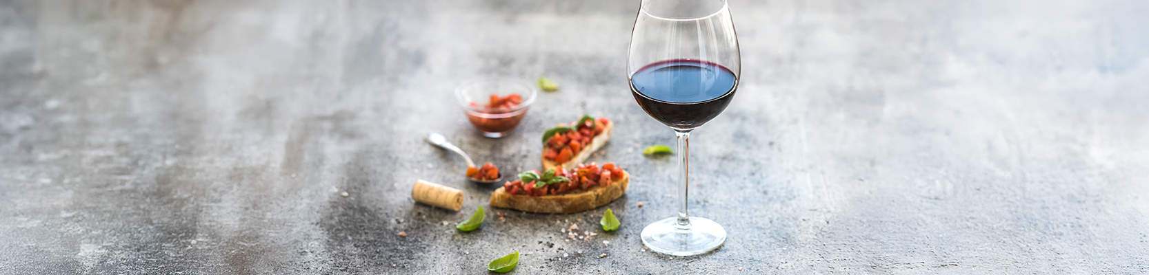 Rotweinglas und Bruschetta.