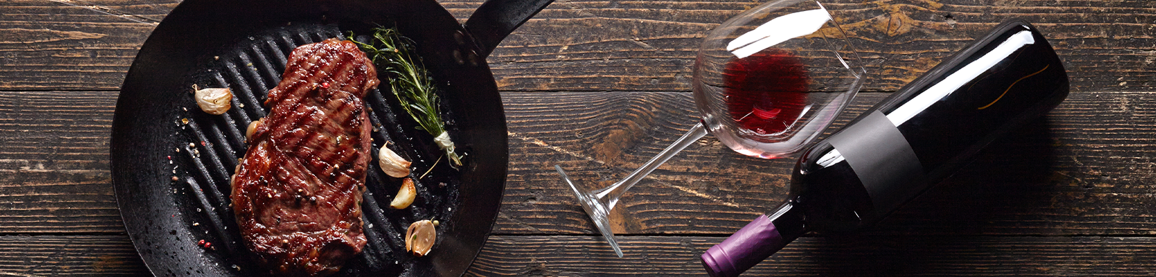 gebratenes Rindfleisch in einer Pfanne auf Holztisch